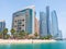 Abu Dhabi, UAE - April 1. 2019. Beach and Khalidiya Palace Rayhaan by Rotana hotel and and Etihad Towers