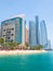 Abu Dhabi, UAE - April 1. 2019. Beach and Khalidiya Palace Rayhaan by Rotana hotel and and Etihad Towers