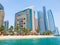 Abu Dhabi, UAE - April 1. 2019. Beach and Khalidiya Palace Rayhaan by Rotana hotel and and Etihad Towers