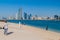 ABU DHABI, UAE - MARCH 7, 2017: People watch the skyline of Abu Dhabi from the Marina Breakwater beach, United Arab Emirat