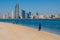 ABU DHABI, UAE - MARCH 7, 2017: People watch the skyline of Abu Dhabi from the Marina Breakwater beach, United Arab Emirat