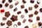 Abundance of chocolates on a light wooden background close up