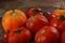 Abundance ripe organic tomatoes on dark rustic background. Colorful tomatoes