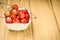 abundance of sweet cherry in a white bowl on a wooden backgroundabundance of sweet cherry in a white bowl on a wooden background.