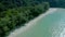 Abundant nature of white beach and forest all around the mountain in the open sky day by angle view from top view drone.