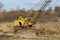 Abundant old, rusty mobile crane left on field.