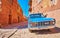 ABYANEH, IRAN - OCTOBER 23, 2017: The vintage blue car is parked in medieval street of historic mountain village, on October 23 in