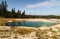 Abyss Pool in the West Thumb Geyser Basin, forest and sky as background Yellowstone National Park, reflections, morning, WY, USA