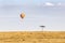 Acacia tree, vultures and hot-air balloon