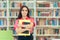 Academic Girl Holding her Book and Papers in a Library