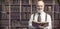 Academic professor in the library holding a book