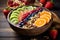 Acai bowl with strawberries, orabges, blueberries, kiwi, nuts and granola on wooden table. Nourishing breakfast full of vitamins,
