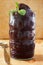 Acai frozen pulp juice in glass with fresh mint