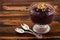 Acai in glass with muesli on wooden table
