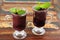 Acai pulp in 2 glass with fresh mint on wooden table