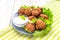 Acaraje or akara snack with green salad and sour cream