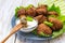 Acaraje or akara snack with green salad and sour cream
