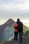 Acatenango, Guatemala - September 2018: A young couple looking an erupting Acatenango volcano after a hike during an evening. The