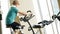 Accelerated footage of a young man working out on the exercise bike in gym