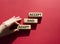 Accept or adapt symbol. Wooden blocks with words Accept and adapt. Beautiful red background. Businessman hand. Business and Accept