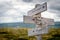 Accept the past text engraved on old wooden signpost outdoors in nature