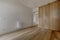 Access hallway to a bedroom with built-in wardrobes with custom-made light oak doors, white painted walls, white shelves on the