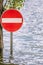 Access prohibition road sign partially submerged in a flood