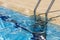 Access stairs to the water, in a swimming pool in summer, Spain