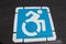 Accessible parking spot icon painted on asphalt
