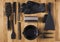 Accessories of black color for hair dyeing on a wooden table. Bowl, brush, comb, foil and other hair salon accessories