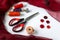 Accessories for sewing: coils of threads, buttons, thimble, scissors and centimeter on a white background