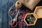 Accessories for sewing and needlework. a casket with bobbins, buttons, scissors and burlap on a dark blue wooden background.