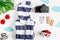 Accessories for treveling with children, camera and suit on white background top view