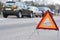 Accident or crash with two automobile. Road warning triangle sign in focus
