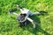 Accident with a drone. Damaged quadcopter on green grass