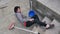 Accidents while cleaning domestic house where a caucasian girl falls off the ladder with broom and dustpan and bucket of water