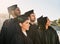 This accomplishment has inspired greatness in them all. a group of students standing together on graduation day.