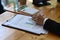 Accountant analyzing financial data on wooden table.