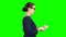 Accountant holds paper money in his hands and considers them. Green screen. Side view