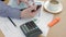 Accountant using his smart phone while working at his desk