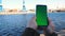 Accounting for cargo in the port. Smartphone with green screen