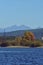 Accumulation dam in autumn season with high mountains on the horizon