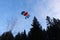 Accuracy skydiving. Skydiver is landing in the forest.