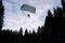 Accuracy skydiving. Skydiver is landing in the forest.