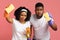 Accurate Black Couple Holding Cleaning Tools And Looking Suspiciosly At Camera