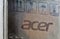 Acer logo closeup on cardboard box surface with warning symbols