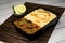 Achari beef pulao biryani rice with cucumber and lemon slice served in dish isolated on wooden table side view of bangladeshi and