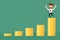 Achievement business man is happy on money stack graph.