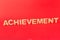 Achievement inscription on red background