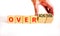 Achiever or overachiever symbol. Businessman turns wooden cubes and changes word Achiever to Overachiever. Beautiful white